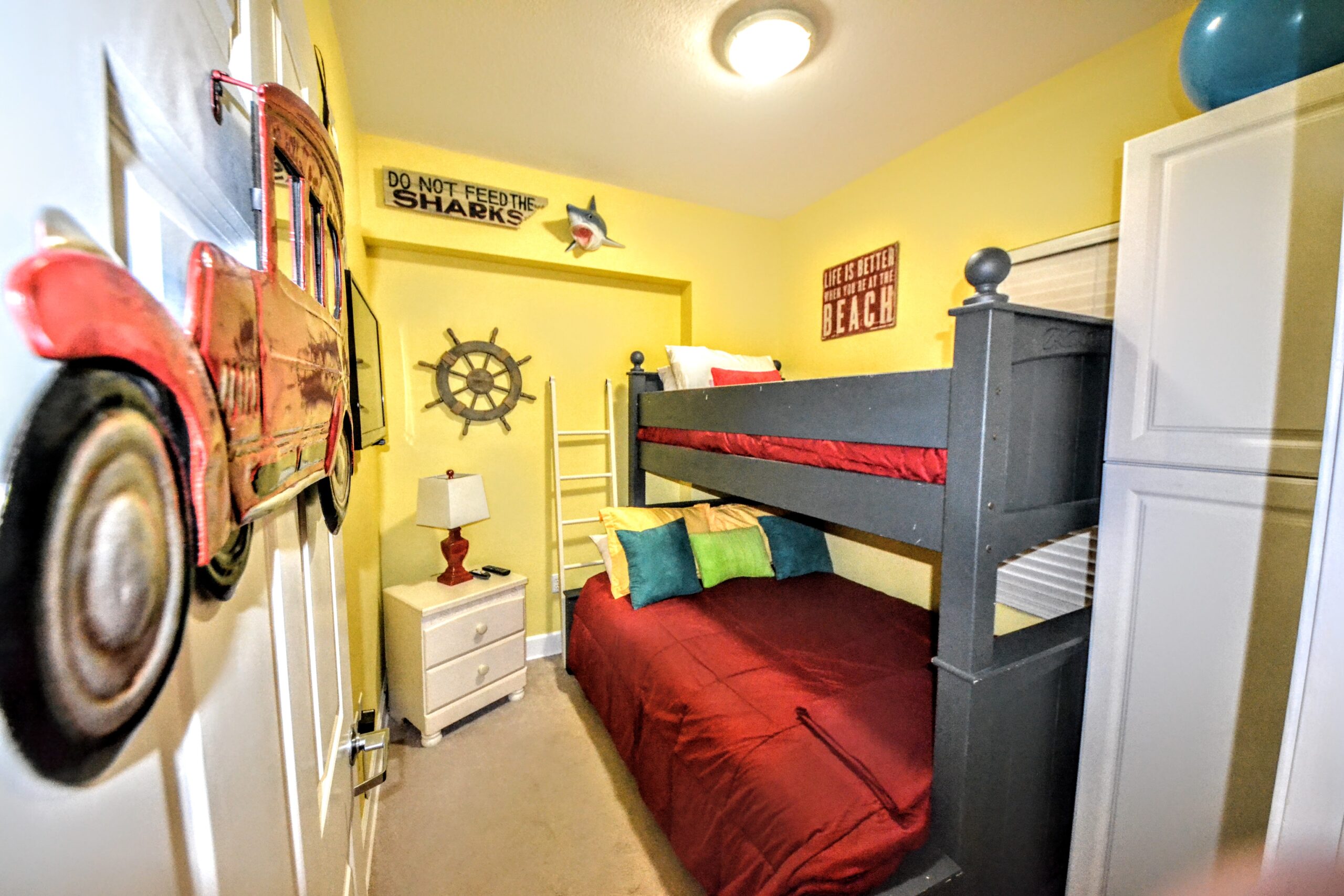 Separate bunk room with door and window in a one-bedroom unit at Sunrise Beach Condos