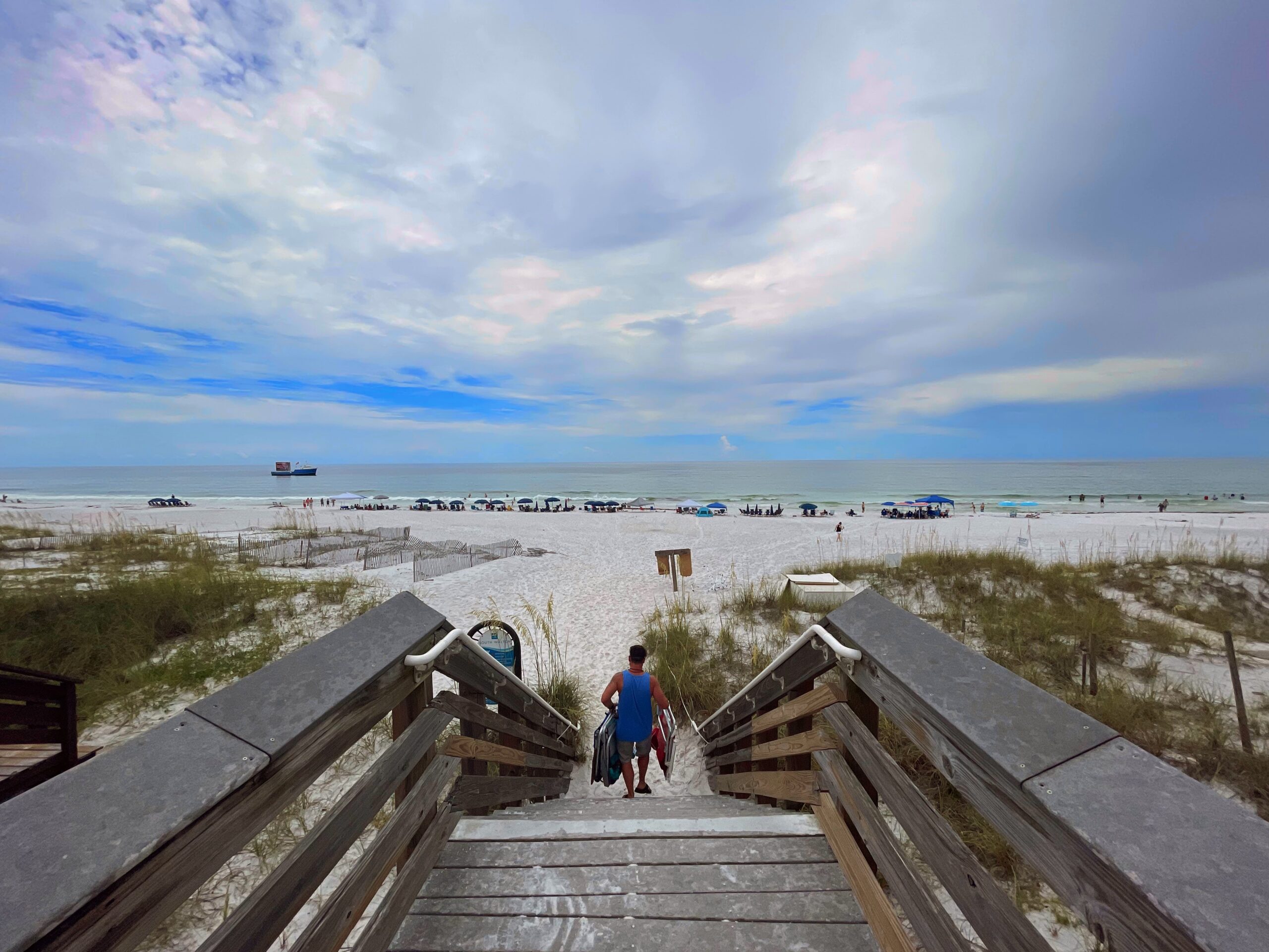 Miramar Beach, Beach Access Stairs, Guy taking chairs to the beach, early morning, beautiful sky. Gulf in Background
