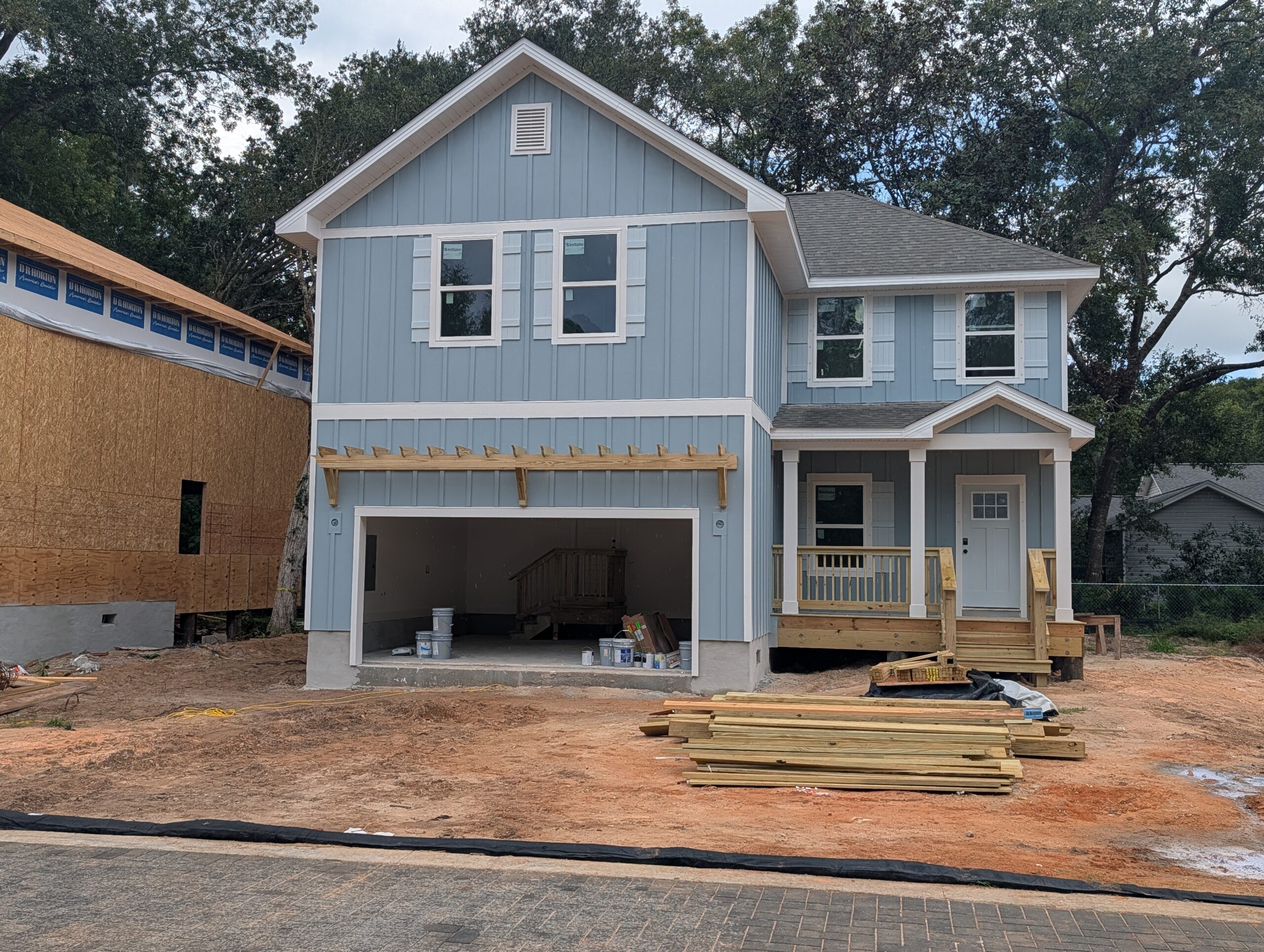 A D.R. Horton home partway through construction, framing and roof complete